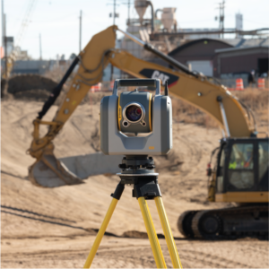 Trimble SX12 at a construction site with a Caterpillar excavator in the background